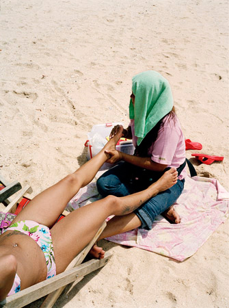  A Thai woman gives a foreign tourist a massage during the mid-day heat.